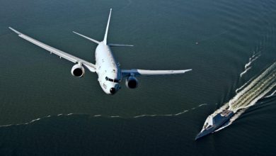 P-8A Poseidon flies over USS Zumwalt