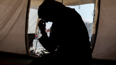 Zahra, whose husband was an ISIS fighter, sits in a camp for internally displaced people in Iraq