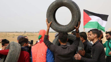 A group of young men in Gaza prepare to light tires on fire ahead of a protest
