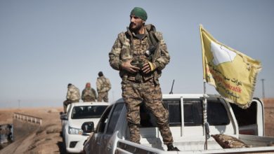 An SDF commander prepares his unit to enter Tal al-Samam