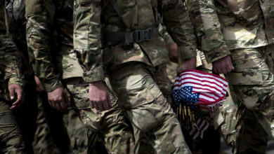 Soldiers in the Old Guard arrive to place flags at graves in Arlington National Cemetery during "Flags In" in preparation for Memorial Day May 25, 2017 in Arlington, Virginia.
