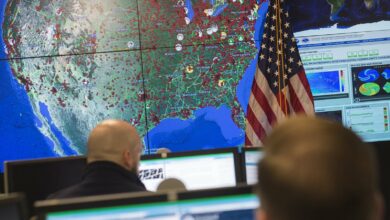 Staff members sit at their work stations at the National Cybersecurity and Communications Integration Center in Arlington, Virginia on January 13, 2015