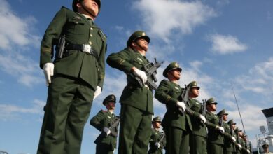 The Chinese coastguard stand in attention.