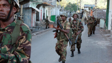 Photo of African Union troops from Tanzania and Comoran troops walking down a street in Anjouan on March 25, 2008