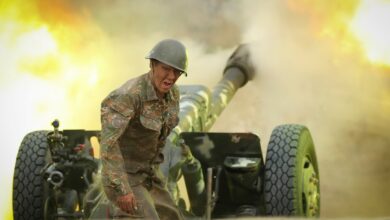 An Armenian serviceman fires a cannon towards Azerbaijan positions in Nagorno Karabakh, Azerbaijan, Tuesday, Sept. 29, 2020.