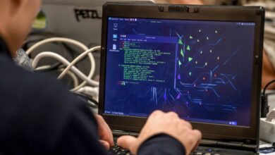 A man works on a laptop during the 11th International Cybersecurity Forum.