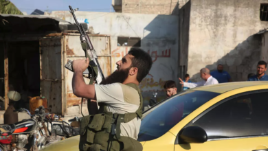 A fighter with the Turkey-backed Faylaq al-Sham rebel faction in Syria shoots in the air during the funeral of 10 of the faction's fighters killed in a Russian air strike