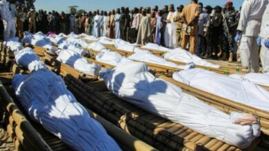 Mourners attend the funeral of 43 farm workers in Zabarmari, Nigeria on Nov 29, 2020 after they were killed by jihadists in rice fields near the village of Koshobe on November 28, 2020