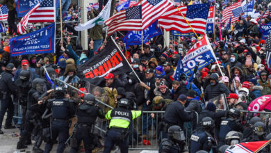 Police and security forces attempt to hold back a mob of pro-Trump extremists as they storm the US Capitol in Washington on January 6, 2021.