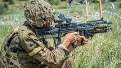A British soldier fires his SA80-A3 with underslung grenade launcher during a live firing platoon level attack Exercise in Kenya.