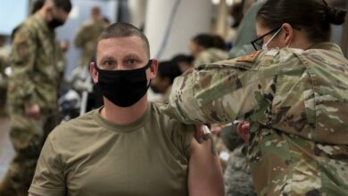 In a handout photo taken on December 29, 2020 by US Forces Korea, a service member of the United States Forces Korea receives the first round of the Moderna vaccine at Osan Air Base, south of Seoul