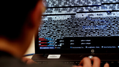 Someone behind a laptop hacking
