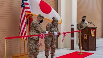 two men cutting ribbons