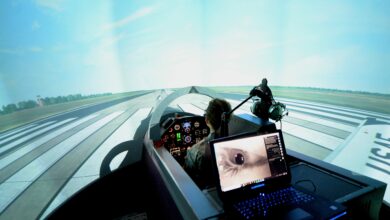 A student pilot prepares to take flight in the T-6 Texan II flight simulator.