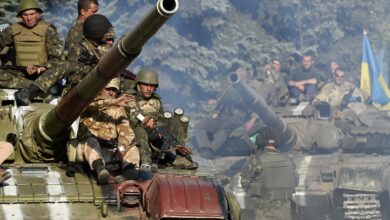 Ukrainian army soldiers ride a tank