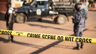 Ugandan police secure the crime scene on Sunday following a bomb blast in capital Kampala