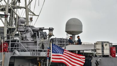 US Navy sailors stand guard aboard the USS Sirocco patrol ship