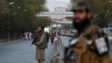 Taliban fighters stand guard near the Sardar Mohammad Dawood Khan military hospital in Kabul