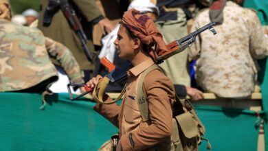 A fighter loyal to Yemen's Houthis attends the funeral of fellow combatants killed in battles with Saudi-backed government troops in Sanaa, February 2021