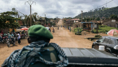 Congolese soldiers drive along the road