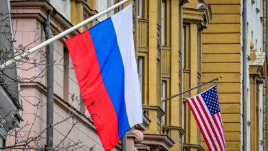 A Russian flag flies next to the US embassy building in Moscow