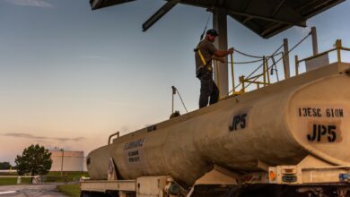 US army employee gauging fuel tanker