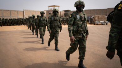 Rwandan soldiers and police officers board a plane at Kanombe airport in Kigali for a military mission to Mozambique