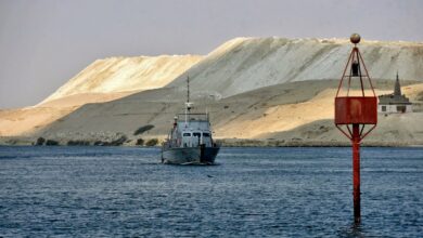 An Egyptian navy craft patrols as ships resume navigation in the Suez Canal