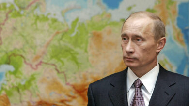 Russian President Vladimir Putin in front of a map in 2006