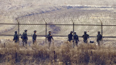 South Korean soldiers check a fence near the demilitarized zone between North and South Korea