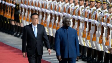 Solomon Islands Prime Minister Manasseh Sogavare and Chinese Premier Li Keqiang inspect honour guards during a welcome ceremony at the Great Hall of the People in Beijing