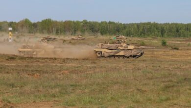 M1A2 Abrams tanks advance onto the battlefield during DEFENDER exercise