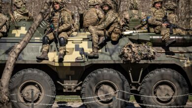 Ukrainian soldiers on top of an armored vehicle