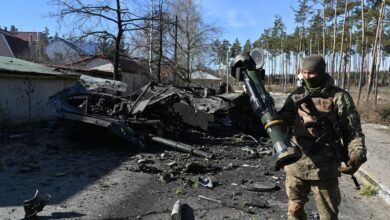 A Ukrainian soldier is seen holding an anti-tank weapon