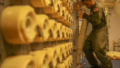 Naval Air crewman loads sonobuoys aboard a P-8A Poseidon aircraft. Photo: Lance Cpl. Joseph Atiyeh/USMC