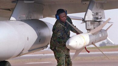 A US weapons technician secures an AGM-88 high-speed anti-radar missile