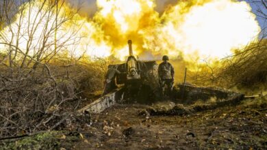 A Ukrainian soldier of an artillery unit fires towards Russian positions