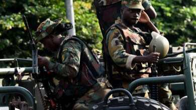 Soldiers sit in a truck on the main road of the Electoral Commission, in Accra, Ghana