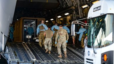 A critical air transport team from the 18th Aeromedical Evacuation Squadron and 15th Medical Group personnel escort a patient into a Negative Pressure Conex-Lite during an aircraft swap at Joint Base Pearl Harbor-Hickam, Hawaii, Sept. 21, 2022. This was the first instance within the U.S. Pacific Air Forces area of responsibility that an NCPL was moved from one aircraft to another while carrying a patient. (U.S. Air Force photo by Staff Sgt. Alan Ricker)