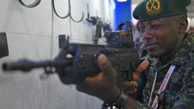 An African soldier checks a weapon at the weapon display session during Africa-India field training exercise (AFINDEX-2023), in Pune on March 29, 2023