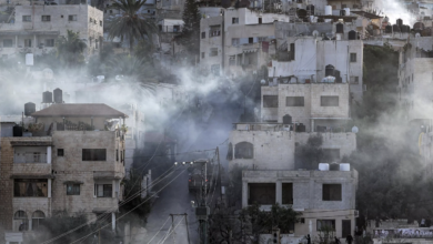 Israeli army vehicles move along a road during a raid in the Jenin camp for Palestinian refugees in the occupied West Bank