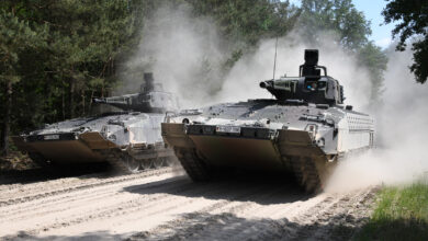 Two PUMA infantry fighting vehicles at full speed on the training grounds in Munster.