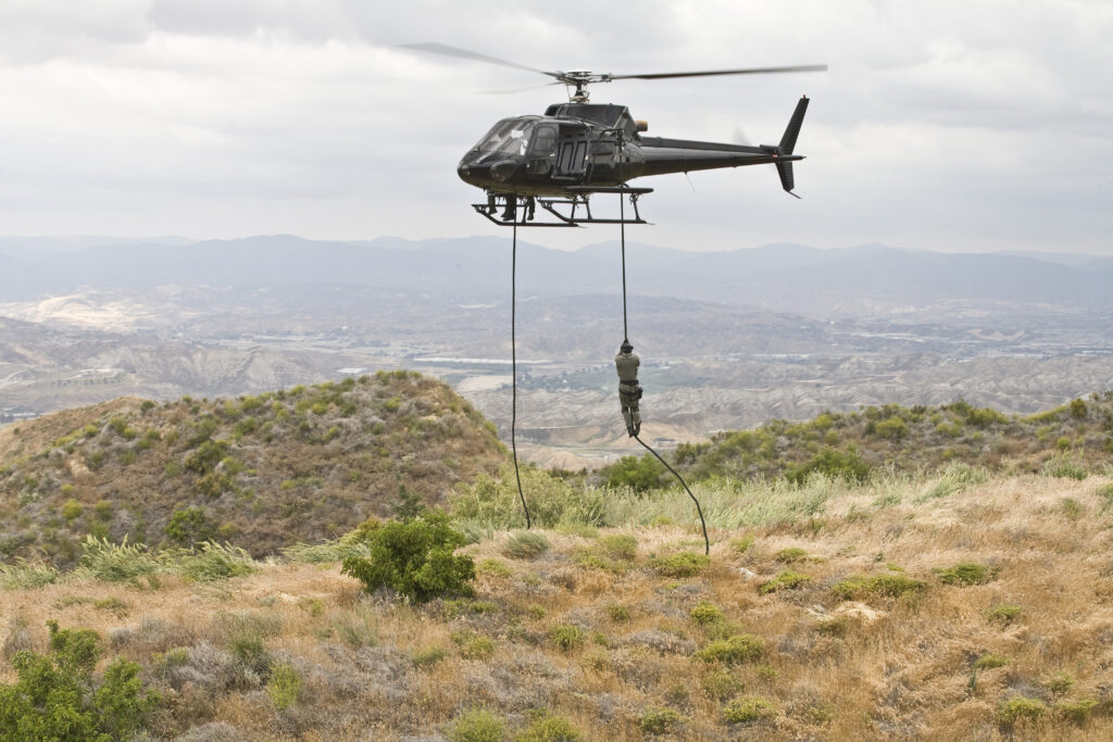 Eurocopter AS350 Ecureuil A-Star Helicopter (now H125) flying over the hills of Malibu, CA during a Fast Rope type military operation.