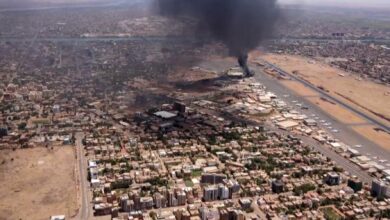 An aerial view shows black smoke rising above the Khartoum International Airport in Khartoum, Sudan