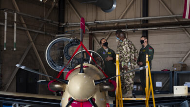 U.S. Air Force Lt. Col. Aaron Jones, left, 81st Fighter Squadron director of operations, explains the operation of an A-29 Super Tucano to Nigerian Air Force Air Vice Marshall Sule Lawal and NAF Group Captain Abdullahi Abu, Nigerian A-29 program foreign liaison officers, Oct. 6, 2020, at Moody Air Force Base, Georgia. The 81st FS conducts combat training for NAF pilots and maintainers in the A-29 Super Tucano. Foreign liaison officers with the NAF, along with representatives of the Air Force Life Cycle Management Center, Air Force International Affairs, the Air Force Security Assistance and Training Squadron, and the Nigerian A-29 program, visited the 81st FS to discuss the future of the program and meet with students. (U.S. Air Force photo by Senior Airman Hayden Legg)