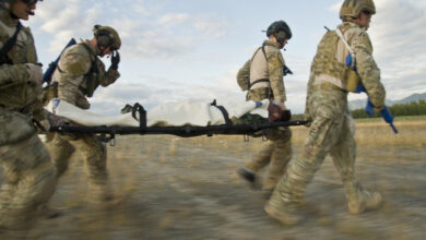 U.S. Air Force pararescuemen also known as PJs (para-jumpers) from the, Alaska Air National Guard Joint Base Elmendorf-Richardson, Alaska, and (Pararescue/Guardian Angels) from Davis Monthan AFB, Tucson, Ariz., transport a wounded body during simulated mass casualty combat training scenario July 30, 2014.
