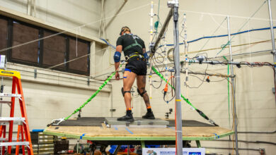 A US Coast Guard Test Participant is free standing on a Moog 6DOF motion simulator while being exposed to simulated Sea State III conditions