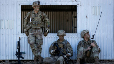 US paratroopers rest after conducting clearance of an enemy village during Exercise Talisman Sabre 2021