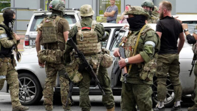 Members of Wagner Group inspect a car in a street of Rostov-on-Don, Russia