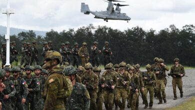 A US V-22 Osprey hovers above Philippine and Australian soldiers at a naval base in San Antonio town in Zambales province.